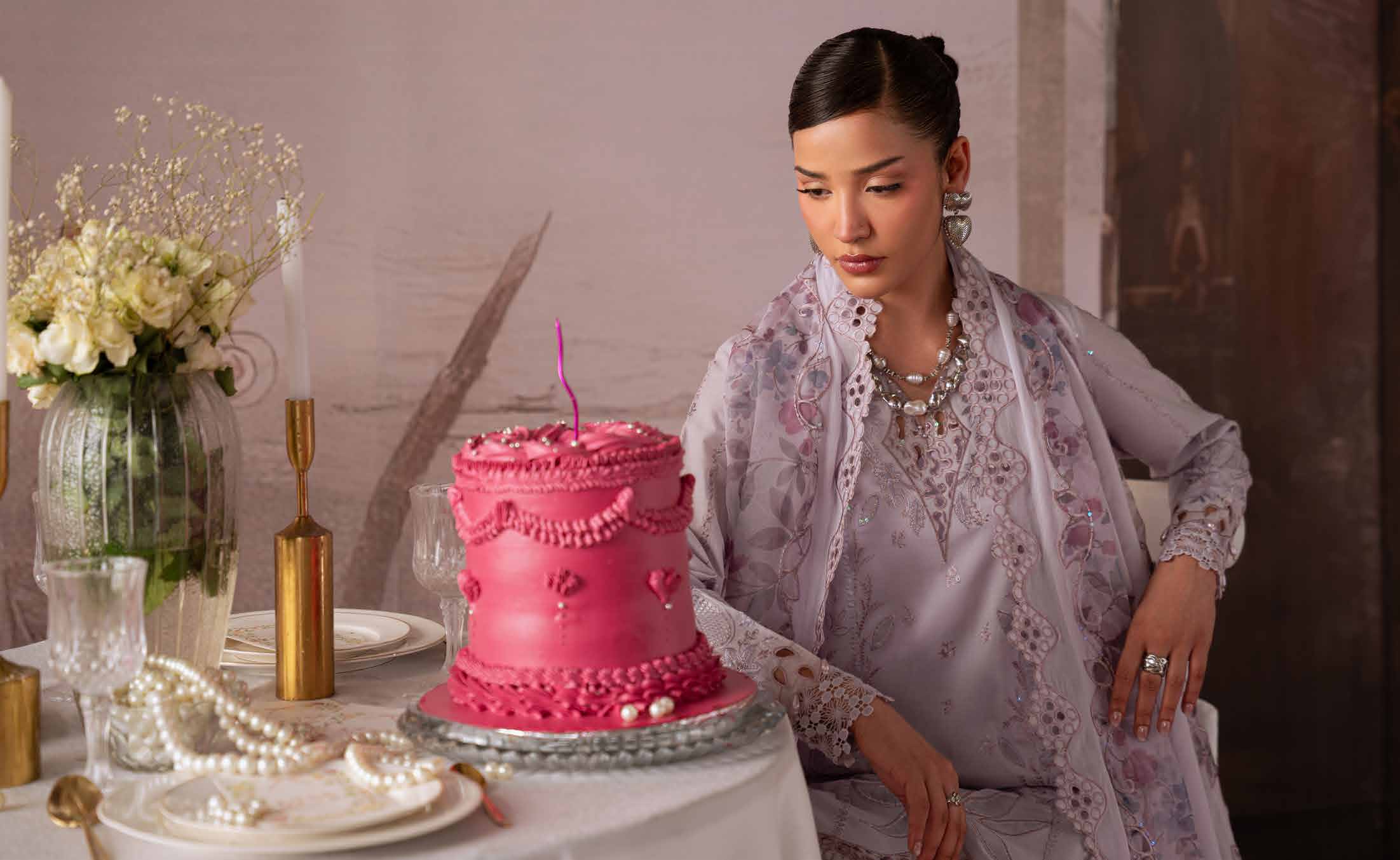 Model wearing a lavender embroidered Pakistani outfit in a styled campaign setting